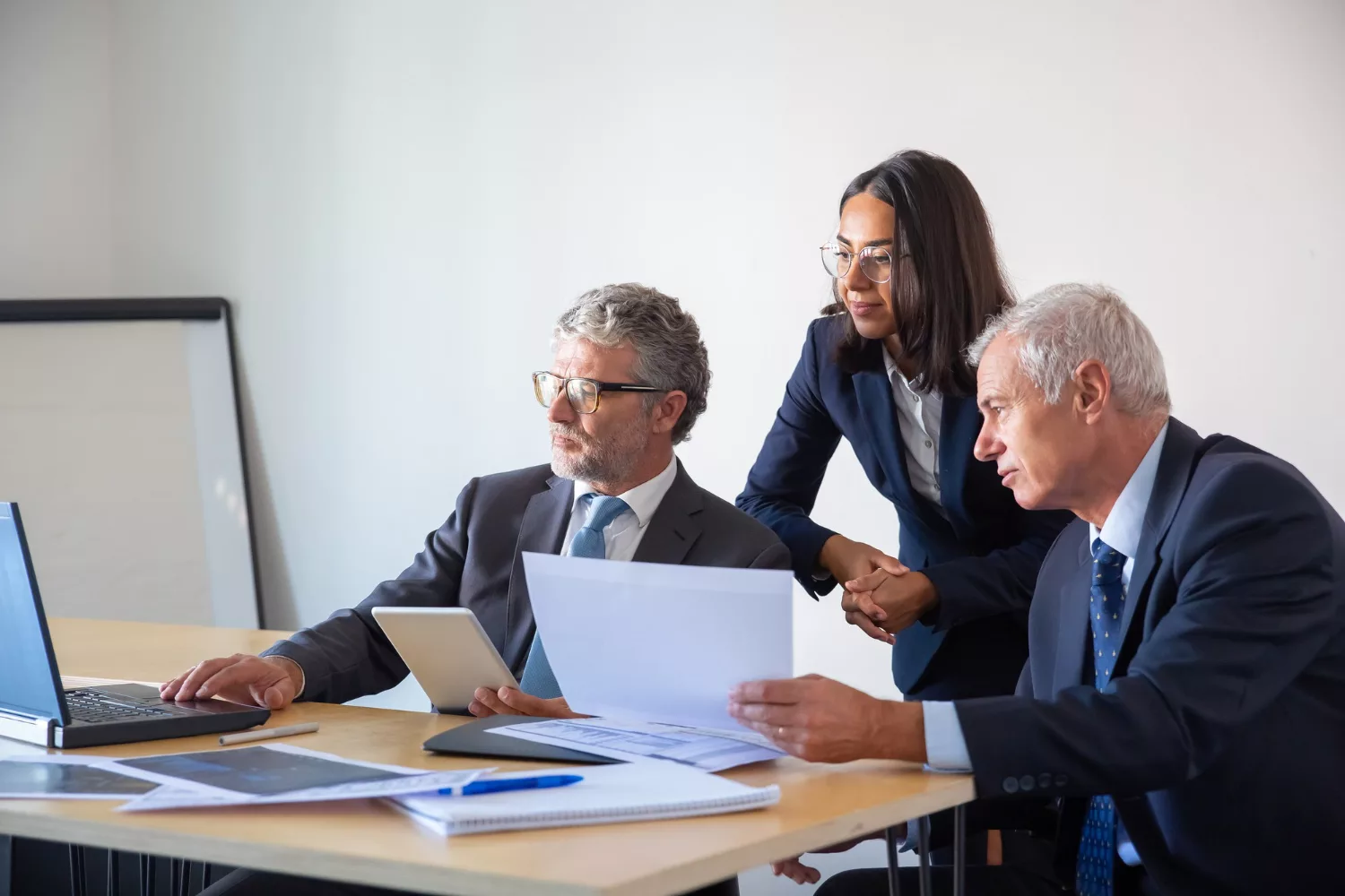 Business professionals discussing "Do I Need Directors and Officers Insurance" in a modern office setting.