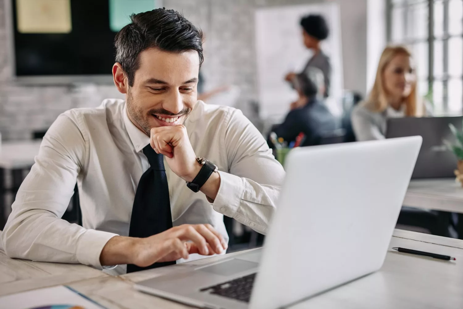 Man smiling at a computer