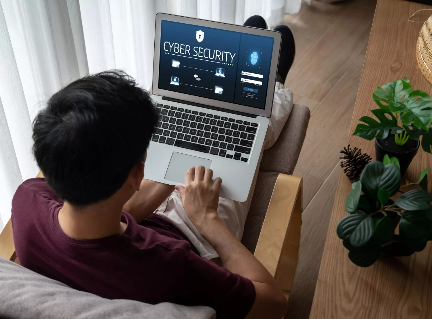 Person using a laptop with a cyber security screen, highlighting the importance of Cyber Liability Insurance.