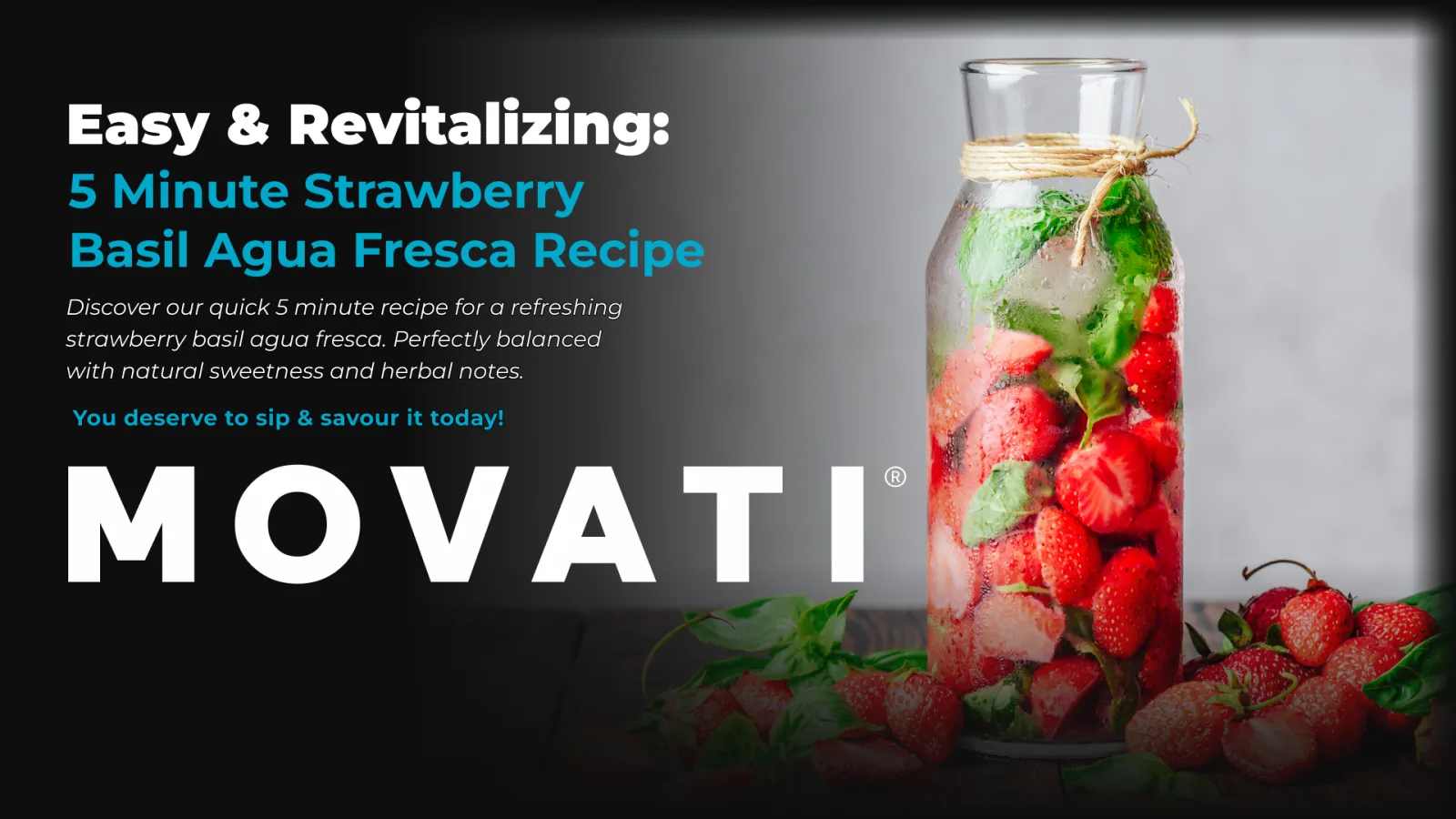 An aesthetic, tall glass jar filled with fresh strawberries and basil, perfect for making strawberry basil agua fresca, sits on a table surrounded by fresh basil and strawberries.