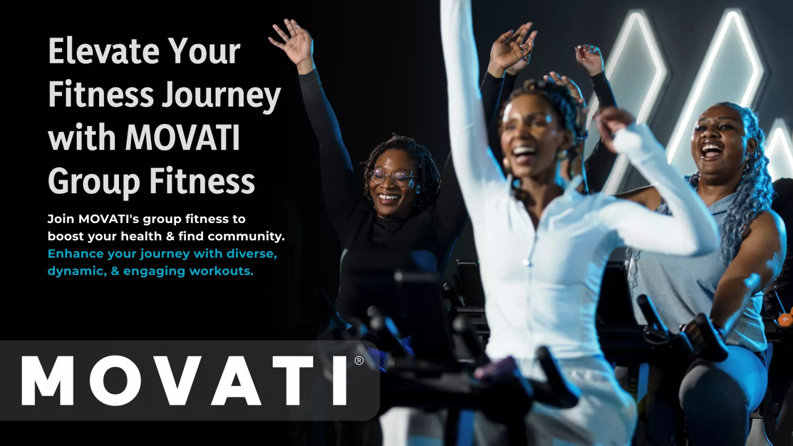 People enthusiastically participating in a MOVATI group fitness class, smiling and raising their arms.