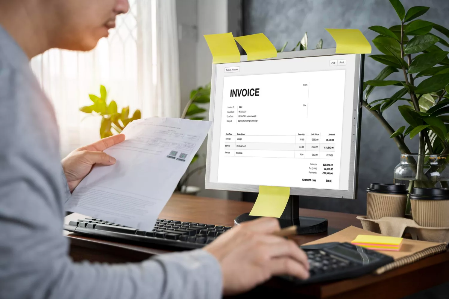 Person reviewing an invoice on a computer screen while tracking and reconciling billing records representing Google Ads invoice tracking.